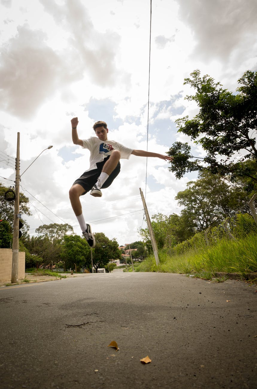 photo of man jumping on the street